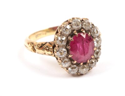 Lot 193 - A Red Stone and Diamond Cluster Ring, the oval cut red stone within a border of old cut...