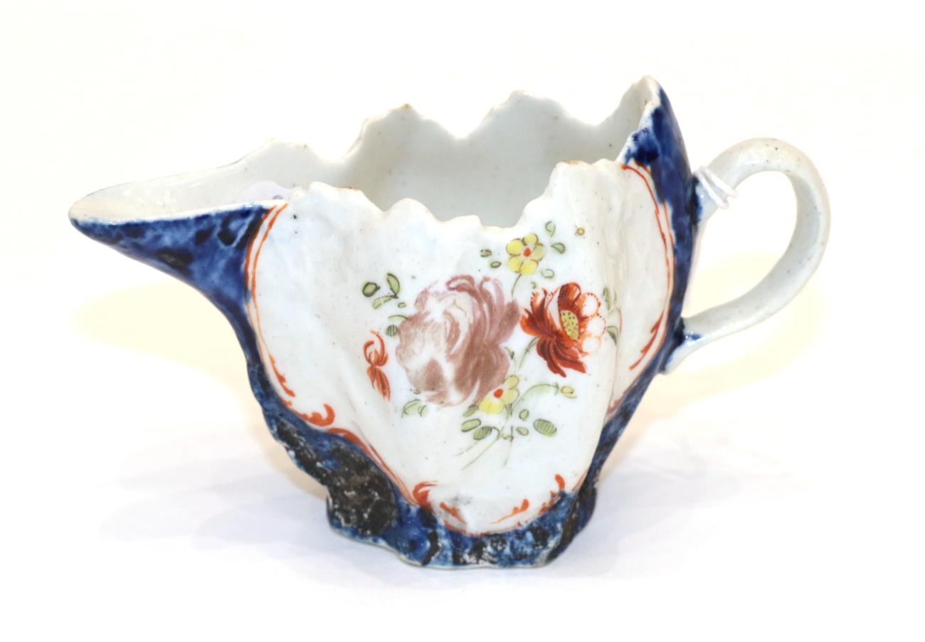 Lot 422 - A West Pans Porcelain Cream Jug, circa 1765, of leaf moulded oval form, painted with flower...