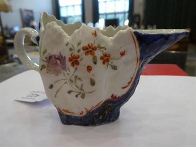 Lot 422 - A West Pans Porcelain Cream Jug, circa 1765, of leaf moulded oval form, painted with flower...