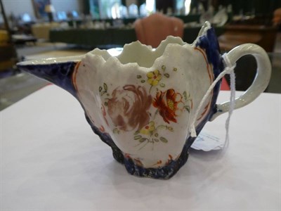 Lot 422 - A West Pans Porcelain Cream Jug, circa 1765, of leaf moulded oval form, painted with flower...