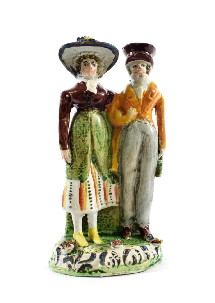 Lot 499 - A Pearlware Figure Group of the Dandies, early 19th century, of traditional form, on a scroll...