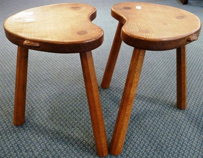 Lot 1763 - A Pair of Robert "Mouseman" Thompson Oak Kidney Cow Stools, on three octagonal legs, each with...