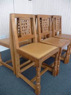 Lot 1767 - A Set of Six Robert "Mouseman" Thompson Oak Lattice Back Dining Chairs, with cow hide studded...