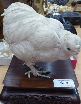 Lot 624 - A Japanese Ivory Model of a Chicken, Meiji period, naturalistically modelled standing on a hardwood