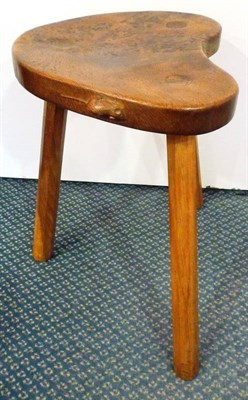 Lot 1771 - A Robert "Mouseman" Thompson Burr Oak Kidney Cow Stool, on three octagonal legs, with carved...