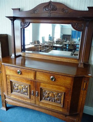 Lot 1789 - An Arts & Crafts Oak Mirror Back Sideboard, probably by Wylie & Lochhead, the back with carved...