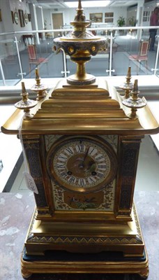 Lot 1529 - An Aesthetic Movement Gilt Metal Porcelain Mounted Striking Mantel Clock with Garniture, circa...