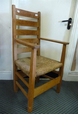 Lot 1791 - An Arts and Crafts Oak Ladder Back Elbow Chair, in the style of Gustav Stickley, with five...