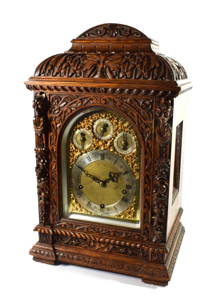 Lot 1546 - A Victorian Carved Oak Chiming Table Clock, circa 1880, elaborately carved case with leaf,...