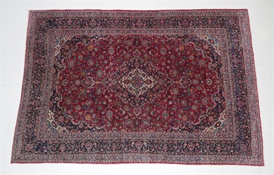 Lot 1585 - Kashan Carpet Central Iran, circa 1940 The raspberry field centred by an ivory and indigo...