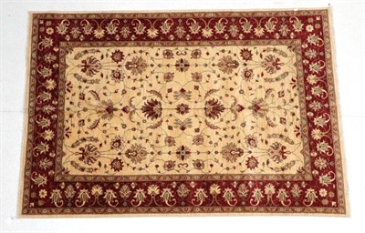 Lot 1602 - Afghan Ziegler Design Carpet, modern The ivory field of vines enclosed by blood red meandering vine