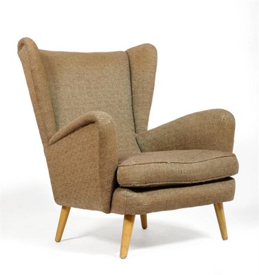 Lot 1799 - A 1960's G-Plan Easy Wing Back Chair, upholstered in tweed fabric, on four circular section...