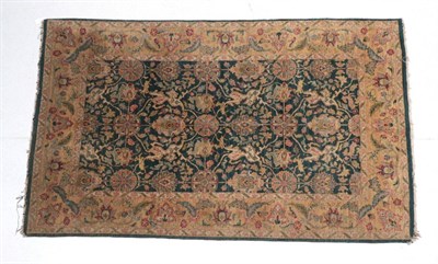 Lot 1619 - Modern Indian Ziegler Design Rug The moss green field of stylised flower heads enclosed by...