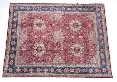 Lot 1639 - Kirman Carpet South East Iran, circa 1950 The crimson field with a flowerhead medallion...