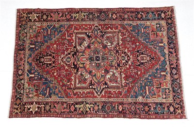 Lot 1640 - Heriz Carpet Iranian Azerbaijan, circa 1910 The terracotta field of angular vines centred by a...