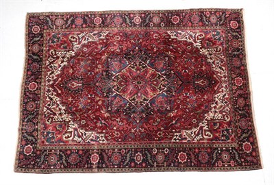 Lot 1641 - Heriz Carpet Iranian Azerbaijan, circa 1940 The blood red field of vines around a flowerhead...