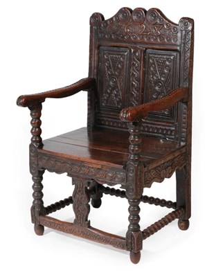 Lot 1644 - A Carved and Joined Oak Wainscot Type Armchair, bearing date 1628, with scrolled top rail above...