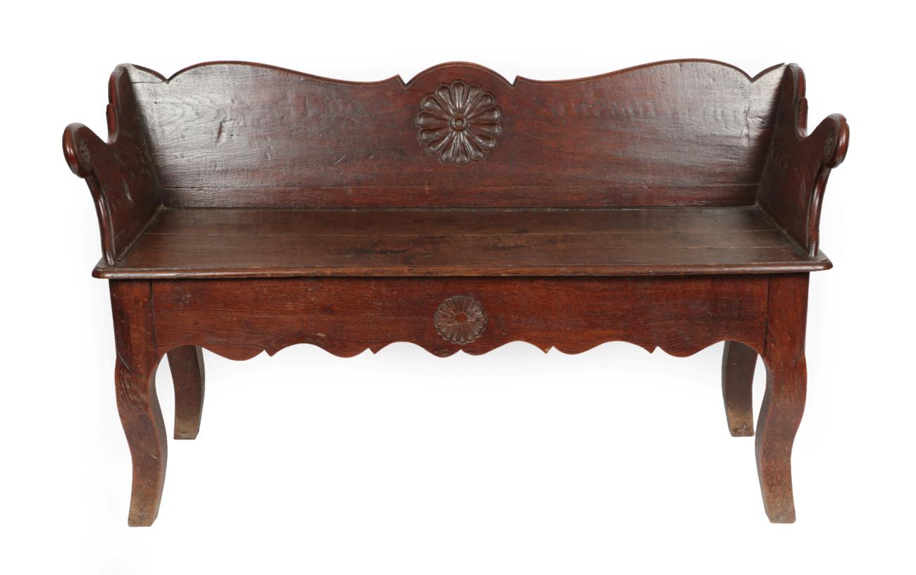 Lot 1655 - A Joined Oak Bench, late 18th/early 19th century, the low back support centred by a carved...