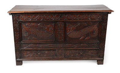 Lot 1657 - A Joined Oak Chest, the hinged lid above two carved panels and two drawers all between S carved...
