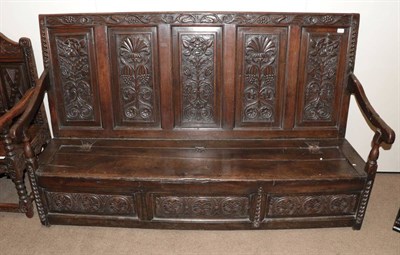 Lot 1658 - A Joined Oak Settle, late 17th/18th century, the back support carved in relief with five panels...