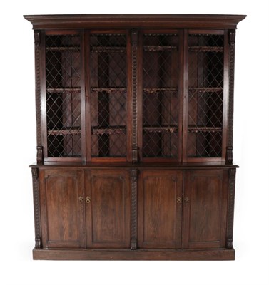 Lot 1660 - A Late Victorian Oak Library Bookcase, circa 1900, the bold cornice above four metal grille...