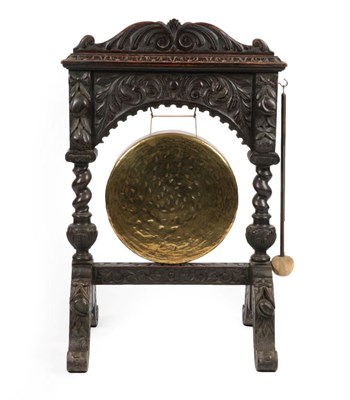 Lot 1663 - A Victorian Carved Oak Dinner Gong with Beater, late 19th century, the carved framework...
