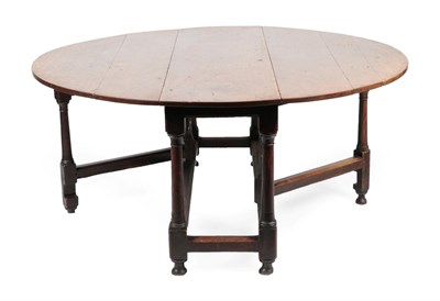 Lot 1676 - An Early 18th Century Six-to-Eight Seater Oak Dropleaf Dining Table, raised on gun barrel...