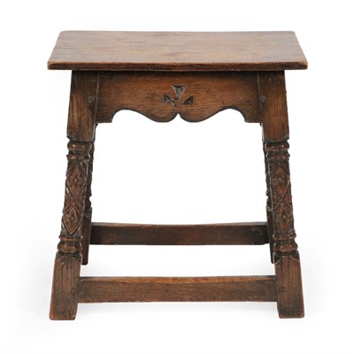 Lot 1677 - A Carved Oak Joined Stool, in 17th century style, the rectangular top above a wavy shaped apron...