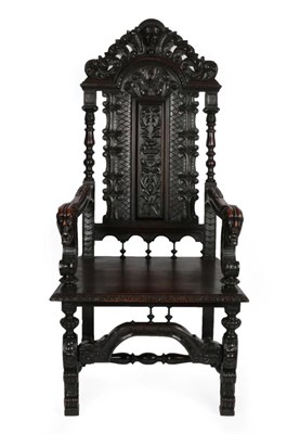 Lot 1679 - An Impressive Victorian Carved Oak Armchair, with acanthus carved top rail above a carved back...