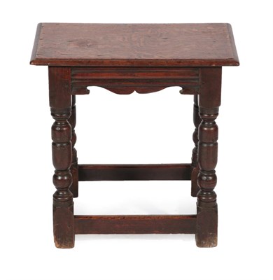 Lot 1682 - An Oak Joint Stool, the moulded and pegged top above a moulded and scrolled apron, on turned...