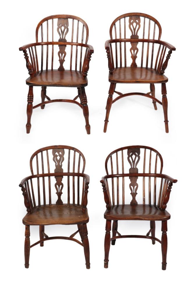 Lot 1687 - A Matched Set of Four Mid 19th Century Yew and Elm Windsor Armchairs, with double pierced...