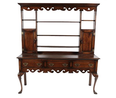 Lot 1689 - A George III Style Oak Dresser and Rack, 20th century, the moulded cornice above a stylised...