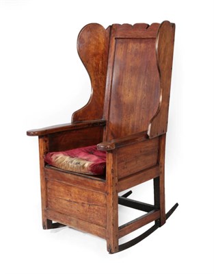 Lot 1695 - A Joined Beech West Lancashire Wing-Back Lambing Chair, the panelled back above flared sides...