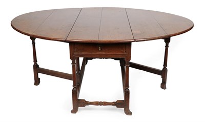 Lot 1697 - An Early 18th Century Six-to-Eight Seater Oak Drop Leaf Table, fitted with a single frieze...