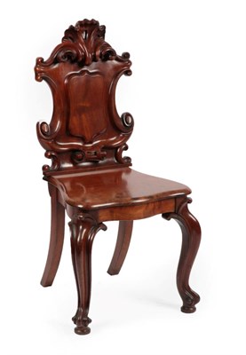 Lot 1701 - A Victorian Mahogany Hall Chair, mid 19th century, the scrolled back support above a vacant...