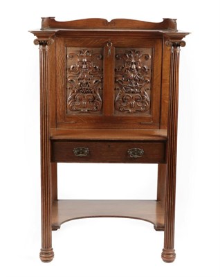 Lot 1708 - A Late Victorian Carved Oak Lady's Desk, late 19th century, the upper section with a...