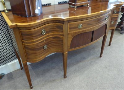 Lot 1727 - A Late George III Mahogany, Satinwood Banded and Ebony Strung Serpentine Shape Sideboard, early...