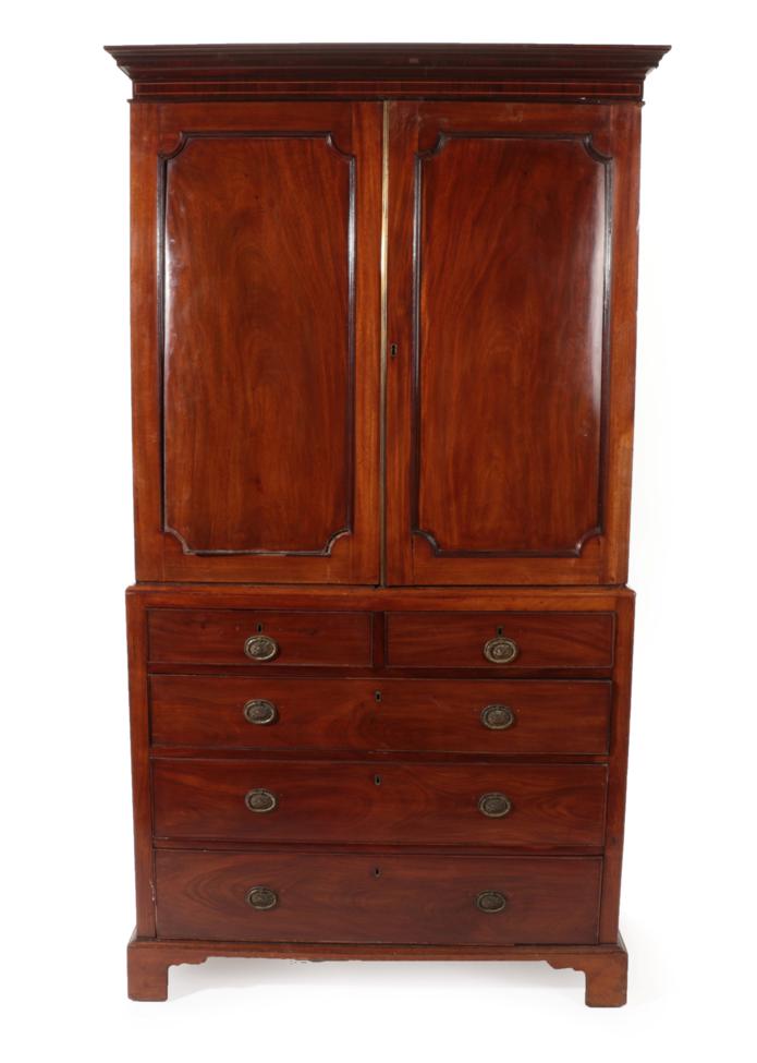 Lot 1774 - ~ A George III Mahogany Linen Press, late 18th century, with moulded cornice above two cupboard...