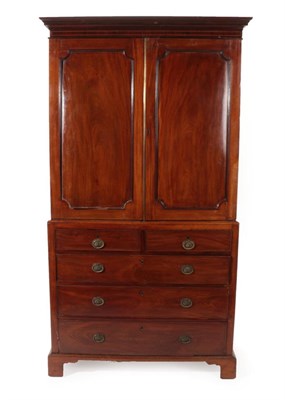 Lot 1774 - ~ A George III Mahogany Linen Press, late 18th century, with moulded cornice above two cupboard...