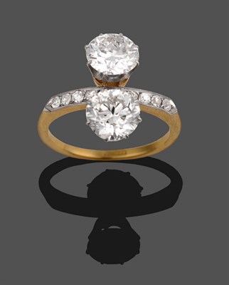 Lot 225 - A Diamond Two Stone Ring, circa 1930, the old brilliant cut diamonds in white claws on gold...