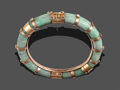 Lot 314 - A Jade Bangle, with bands at intervals, each band collet set with a cabochon gem stone, in a...