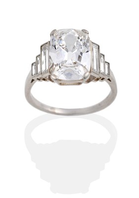 Lot 379 - A Diamond Ring, circa 1935, a cushion cut diamond with graduated baguette cut shoulders, on a plain