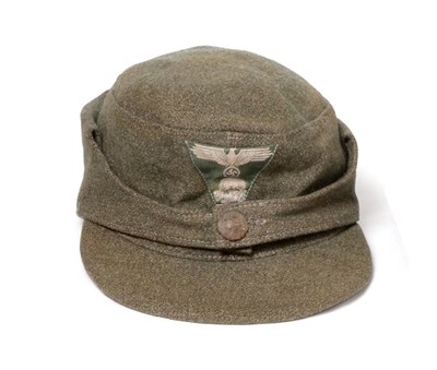 Lot 168 - A German Third Reich SS EM's M43 Field Cap, in grey/green wool, with BeVo woven SS eagle and...