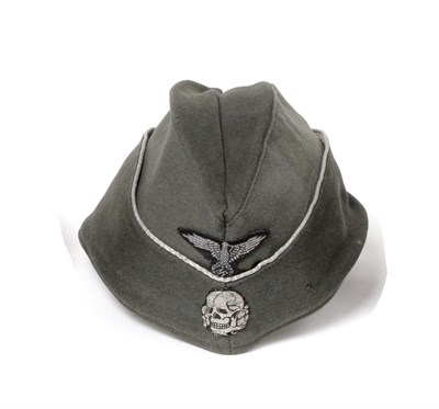 Lot 169 - A German Third Reich SS Officer's Overseas Cap, in field grey wool mix, the fold-down sides...