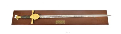 Lot 275 - An Elizabeth II Presentation Sword by Wilkinson Swords, the 86cm double edge steel blade etched...