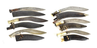 Lot 323 - Six Various Indian Kukris, two with bone grips and sharpening knives, one with brass and horn...