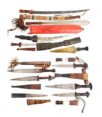 Lot 327 - A Collection of Fourteen Various African Edged Weapons, including six arm daggers with leather...