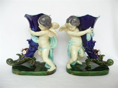 Lot 22 - A Pair of Majolica Cornucopia Vases, late 19th century, supported by a putti on oval bases...