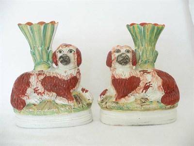 Lot 24 - A Pair of Staffordshire Pottery Spaniel Spill Vases, circa 1870, the recumbent animals with...