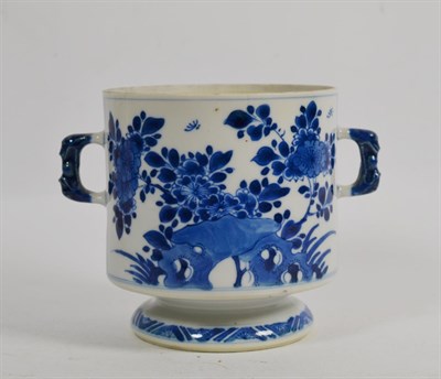 Lot 52 - An 18th century Kangxi blue and white porcelain twin handled cup, (lacking cover), decorated...